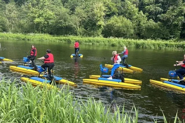 Family group enjoying hydrobike water activity on the river.